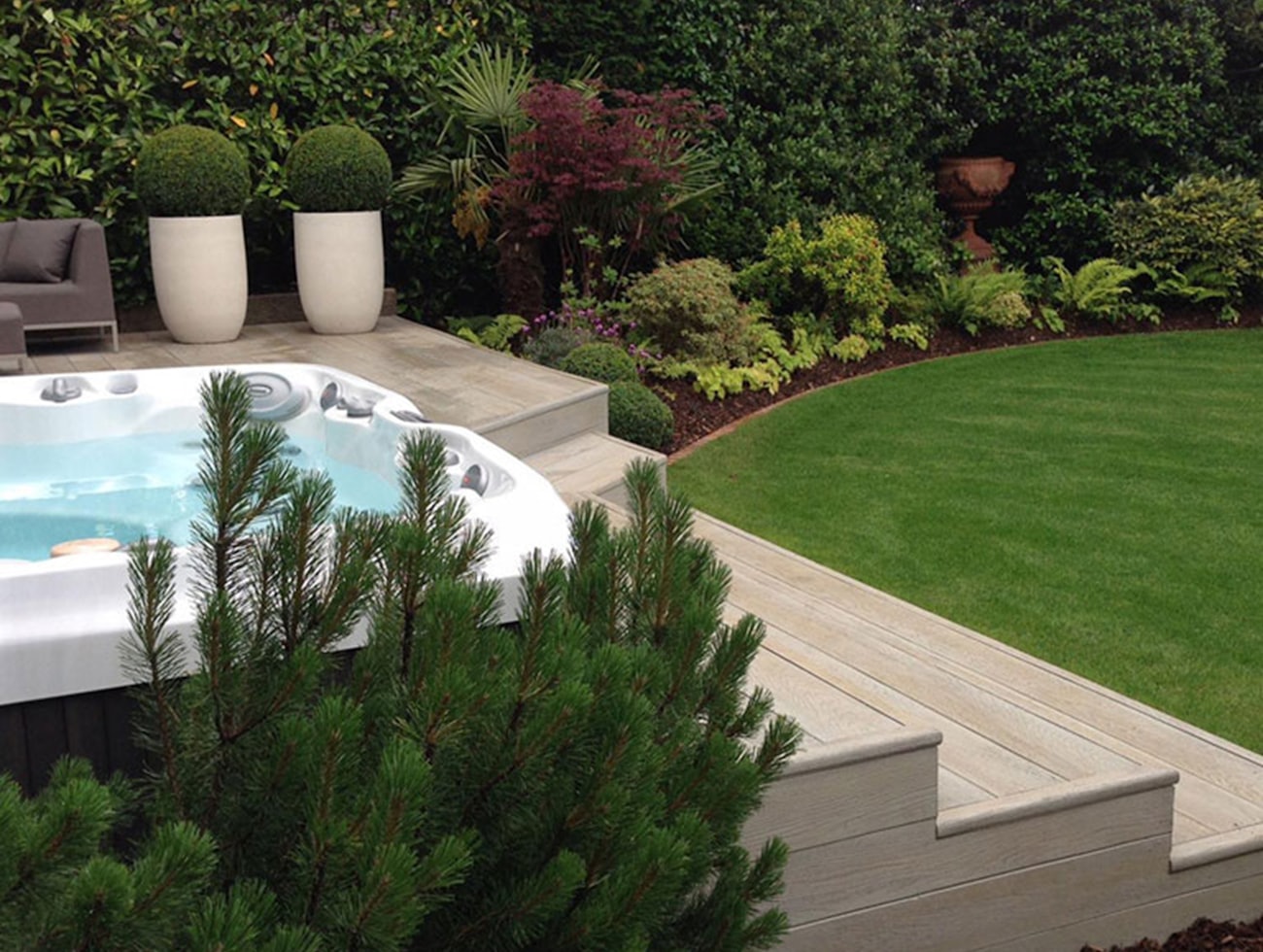 Modern backyard with pool, deck and manicured lawn