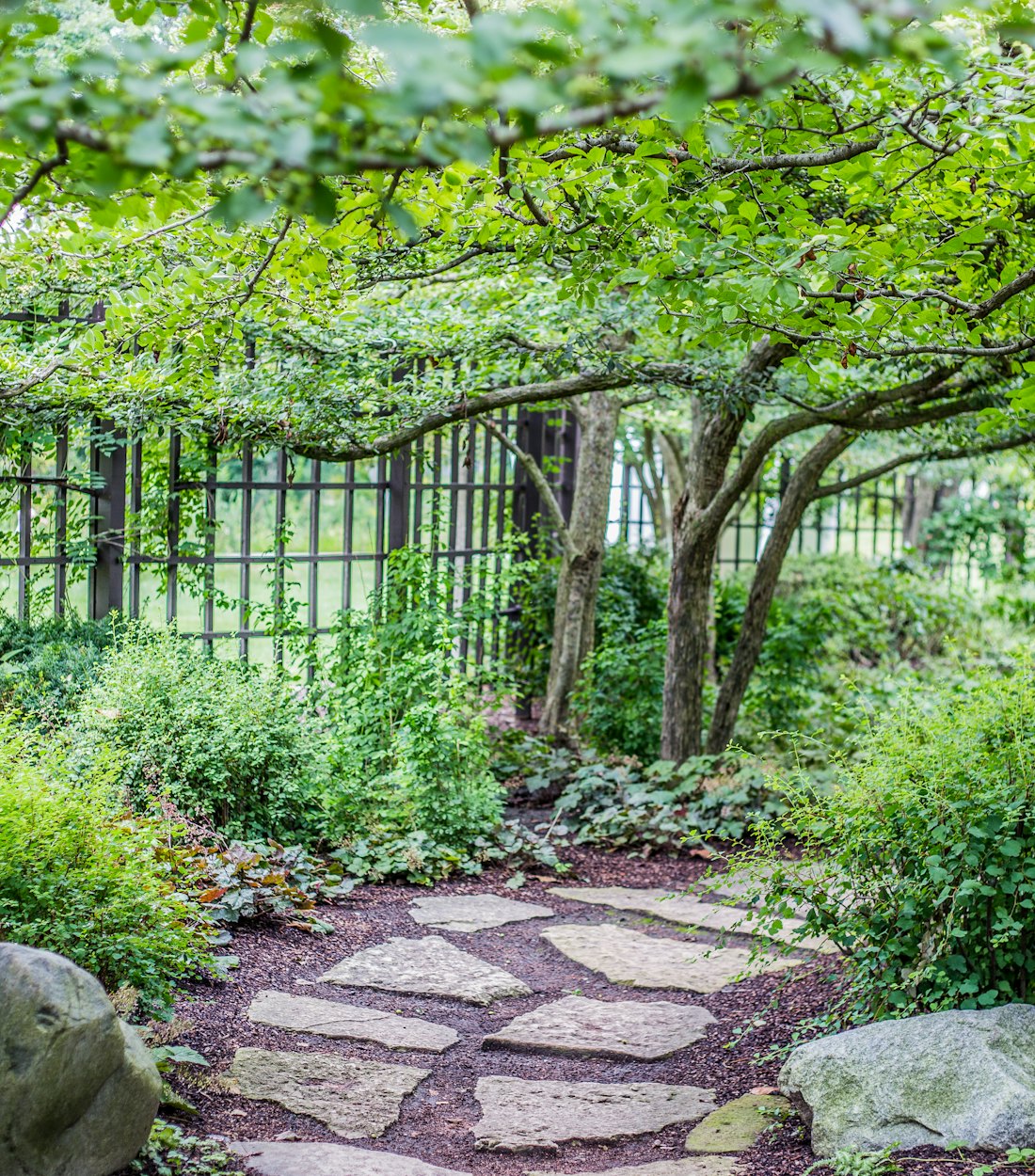 Natural flagstone walkway through a shaded garden